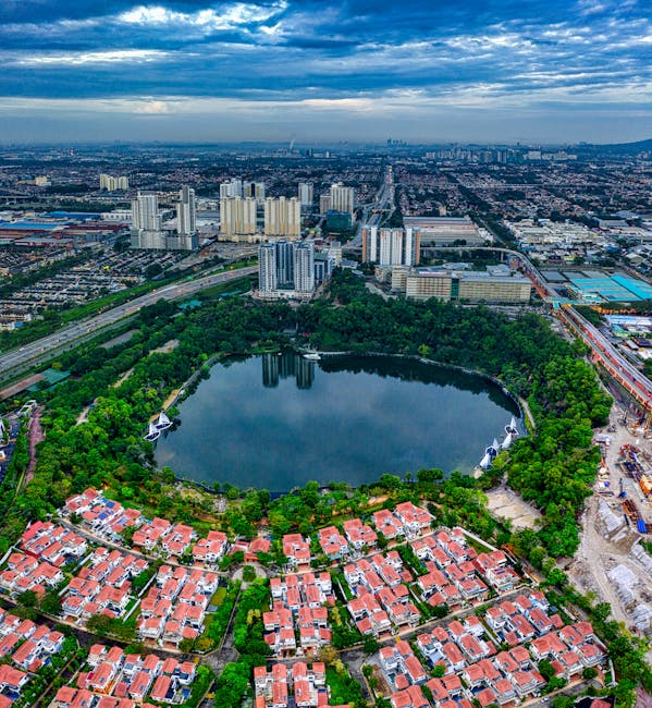 Stunning aerial view over Subang Jaya, Malaysia, showcasing urban architecture and a central lake.